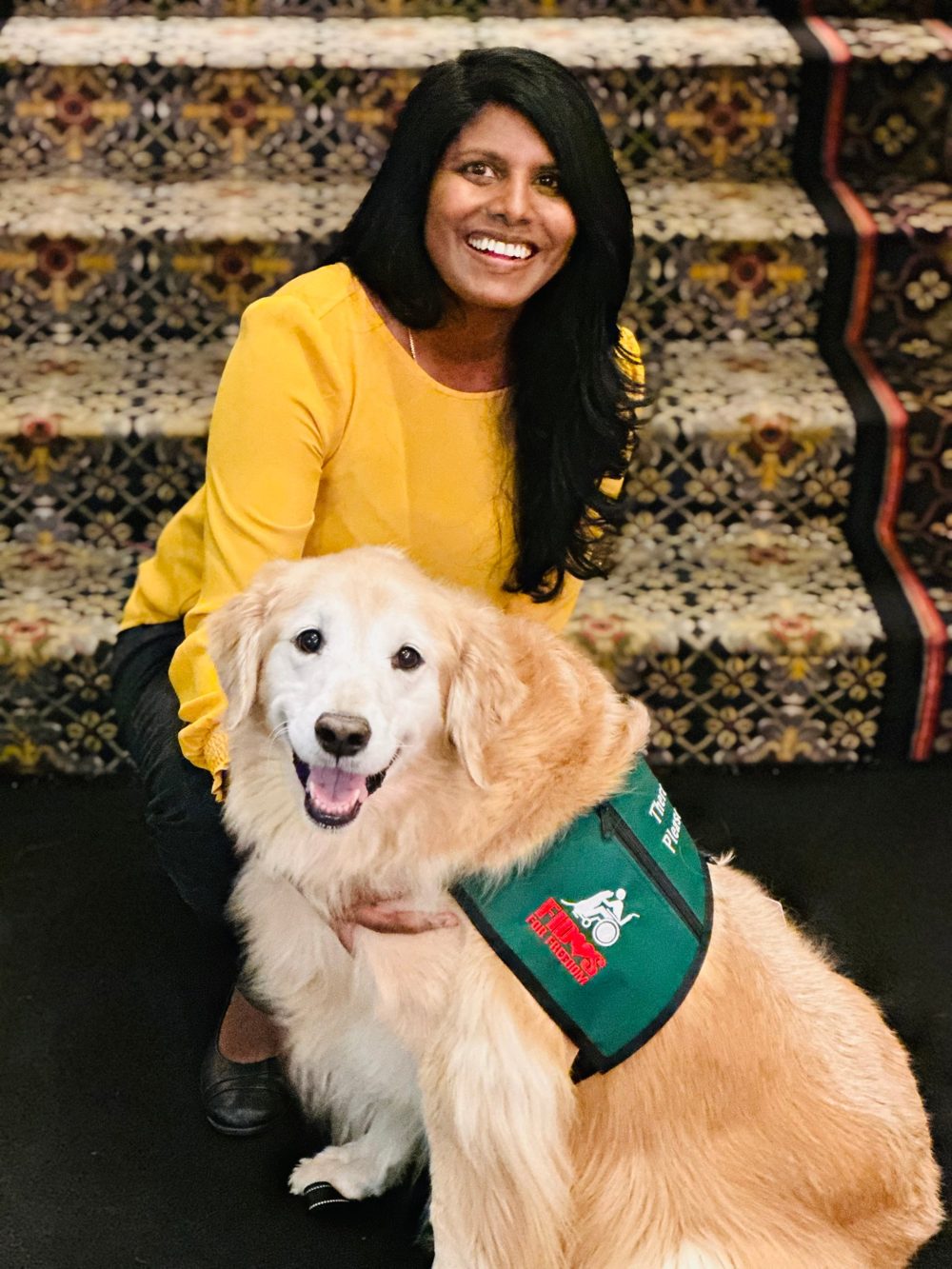 Reka Montfort with her golden retriever therapy dog, Sydney